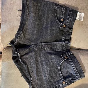 Distressed black Levi’s jean shorts, size W:27